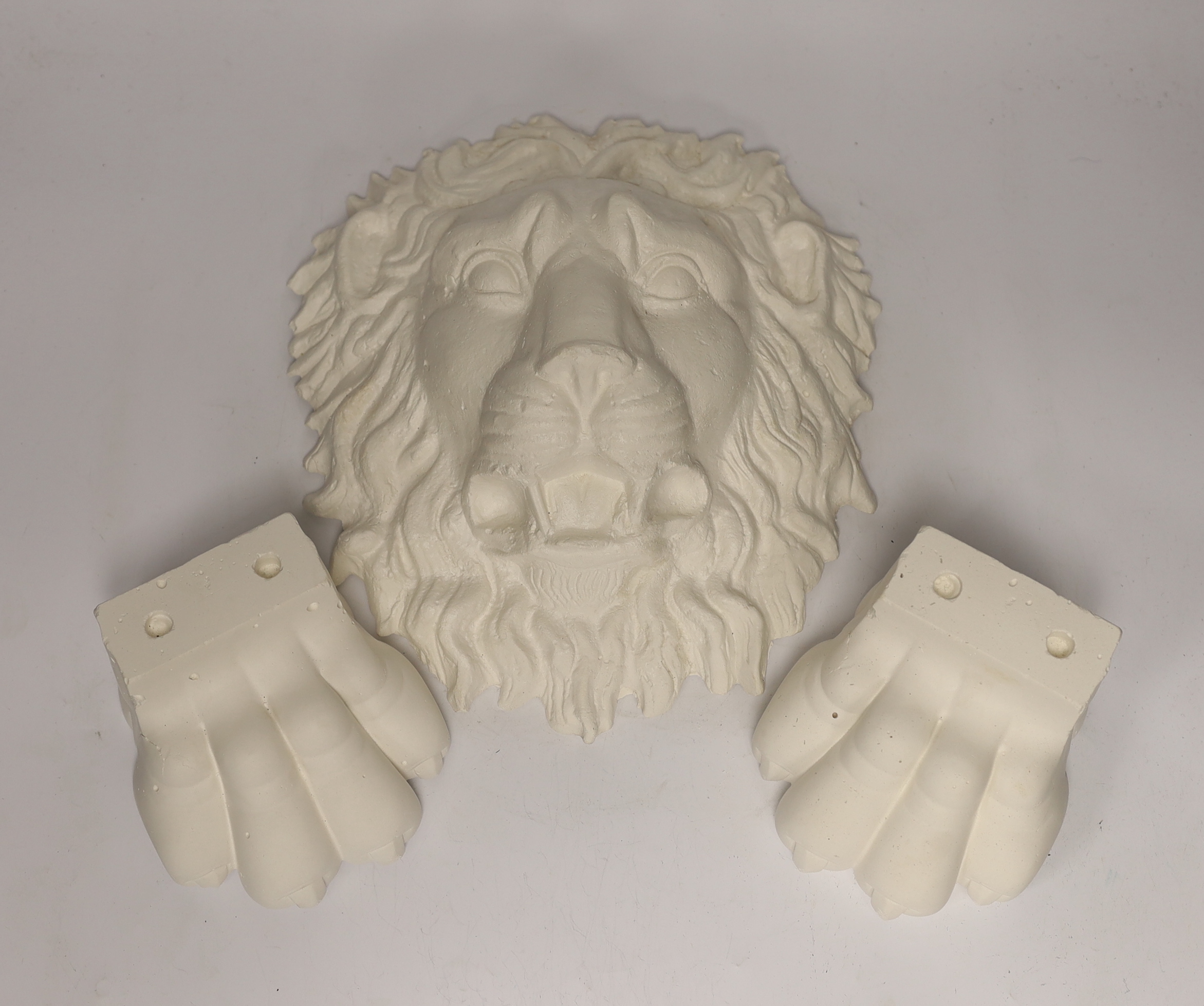 A plaster griffin Roman lion and a pair of lion paws